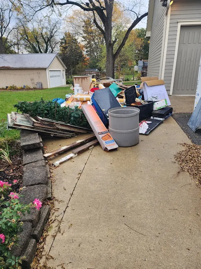Dumpster being loaded with debris for Residential Dumpster Rental in Murillo